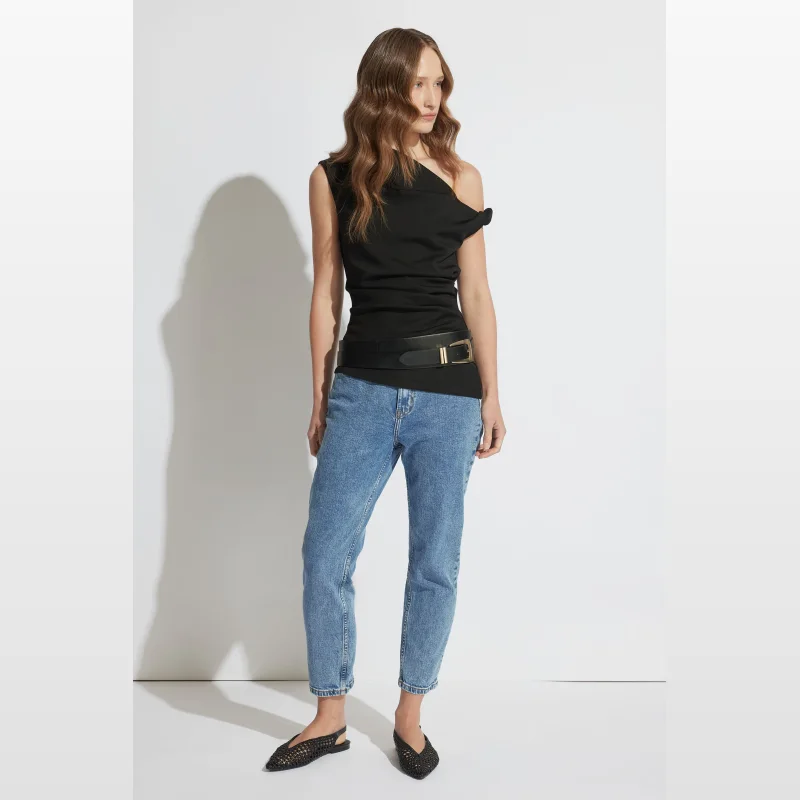 Woman wearing Decjuba Alexa Girlfriend Jeans in a light blue wash, featuring a mid-rise waist and cropped slim leg.