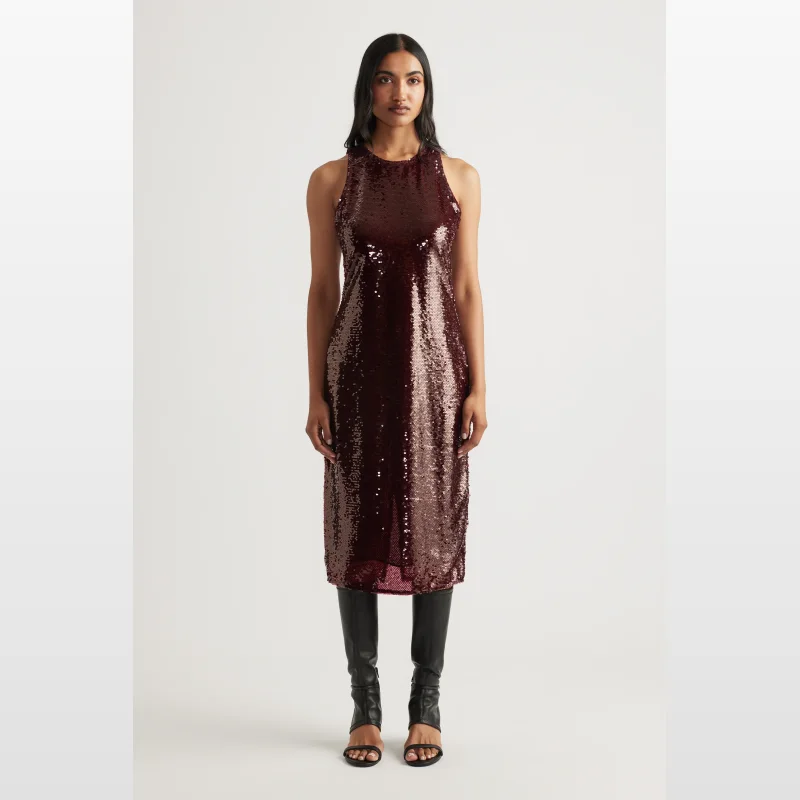 Woman wearing a burgundy sequin midi dress with a scoop neckline and sleeveless design, paired with black gladiator sandals.