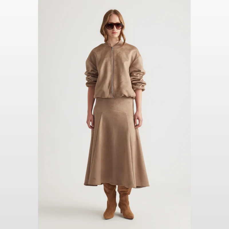 Model wearing a tan faux suede midi skirt with a basque waist and A-line silhouette.