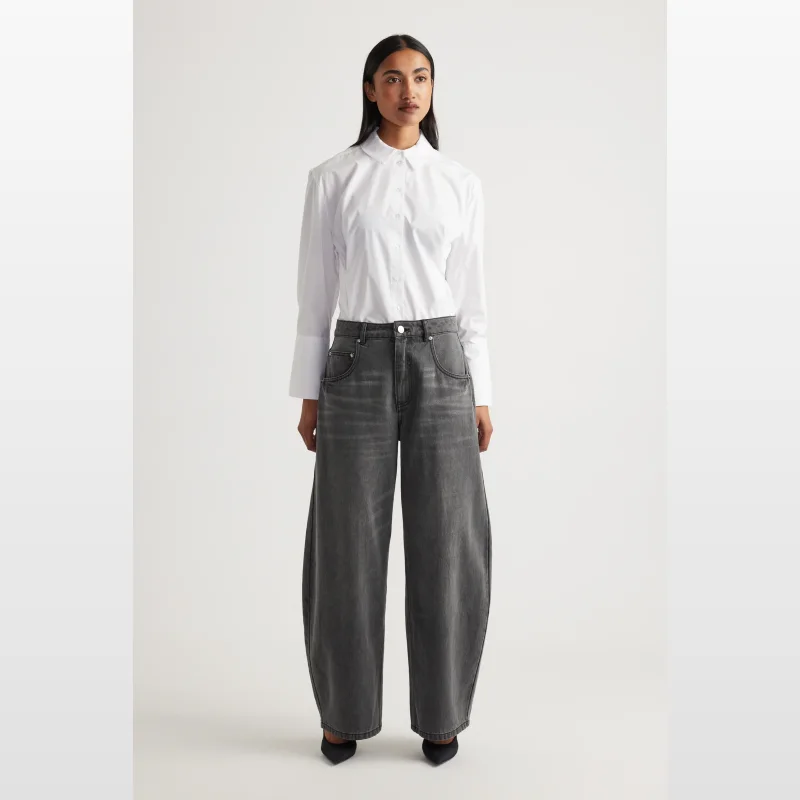 Woman wearing Decjuba Daisy Horseshoe Jeans in grey, a high-rise, full-length wide-leg style with a button and zip fly.
