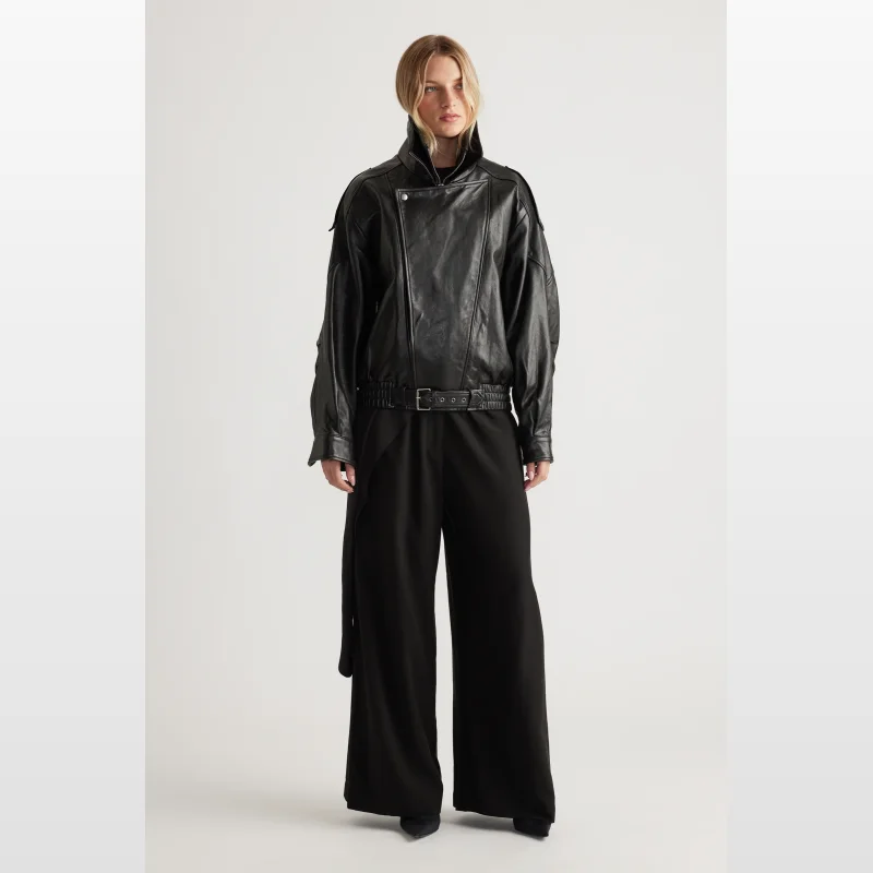 Model wearing Decjuba Elena Palazzo Pants in black, featuring a wide leg and flat waistband.