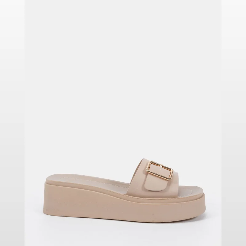 A single beige wedge sandal with an open toe and a wide strap featuring a gold-tone buckle detail, presented against a white background.