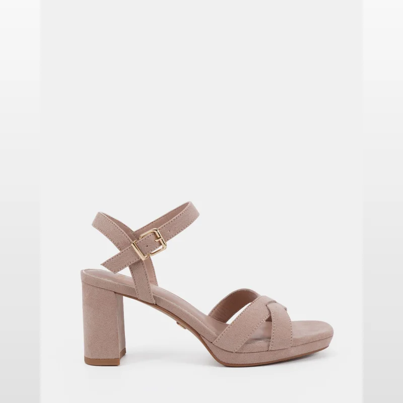 A single nude coloured high heel sandal with a block heel, platform sole, crossover straps, and an ankle strap with a gold buckle.