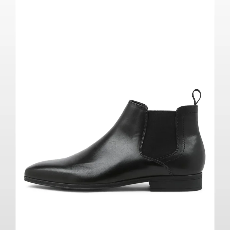 Side view of a black leather Chelsea boot with elastic gussets and a pull tab.