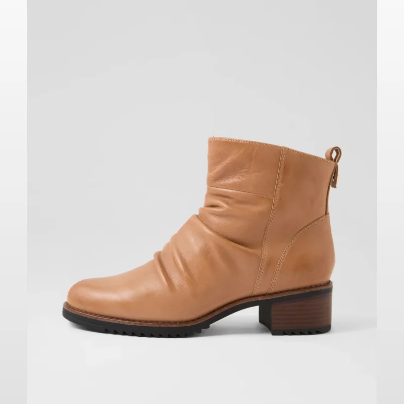 Side view of a tan leather ankle boot with ruched detailing on the vamp and a stacked block heel.