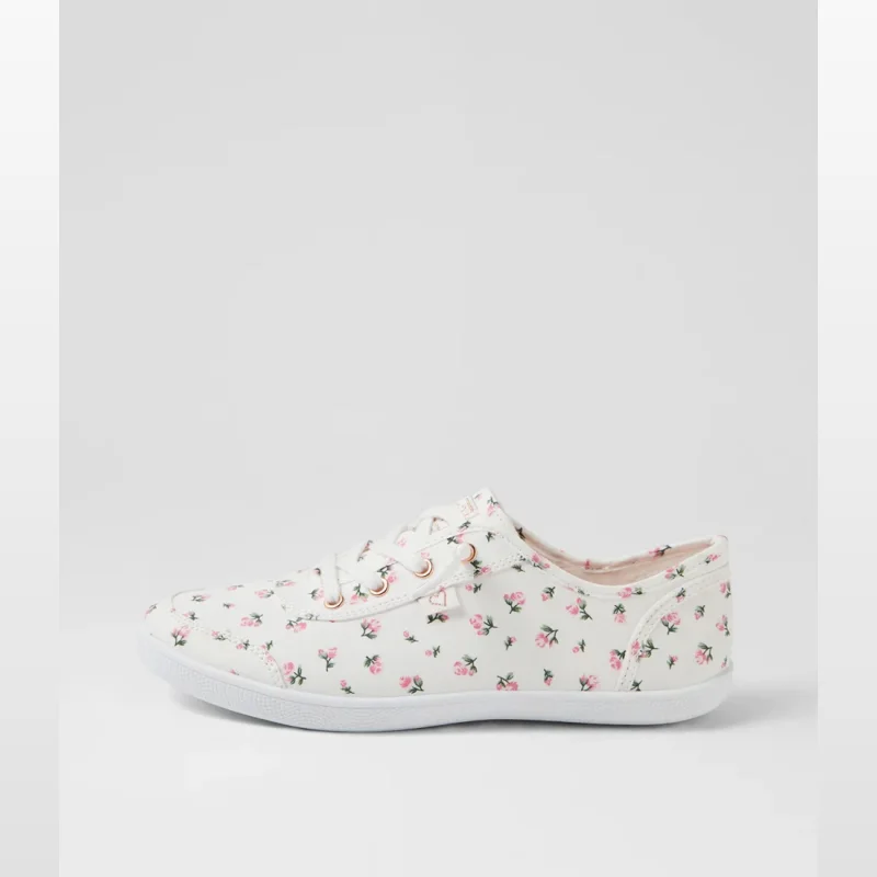 Side view of a white canvas lace-up sneaker with a small pink floral print.