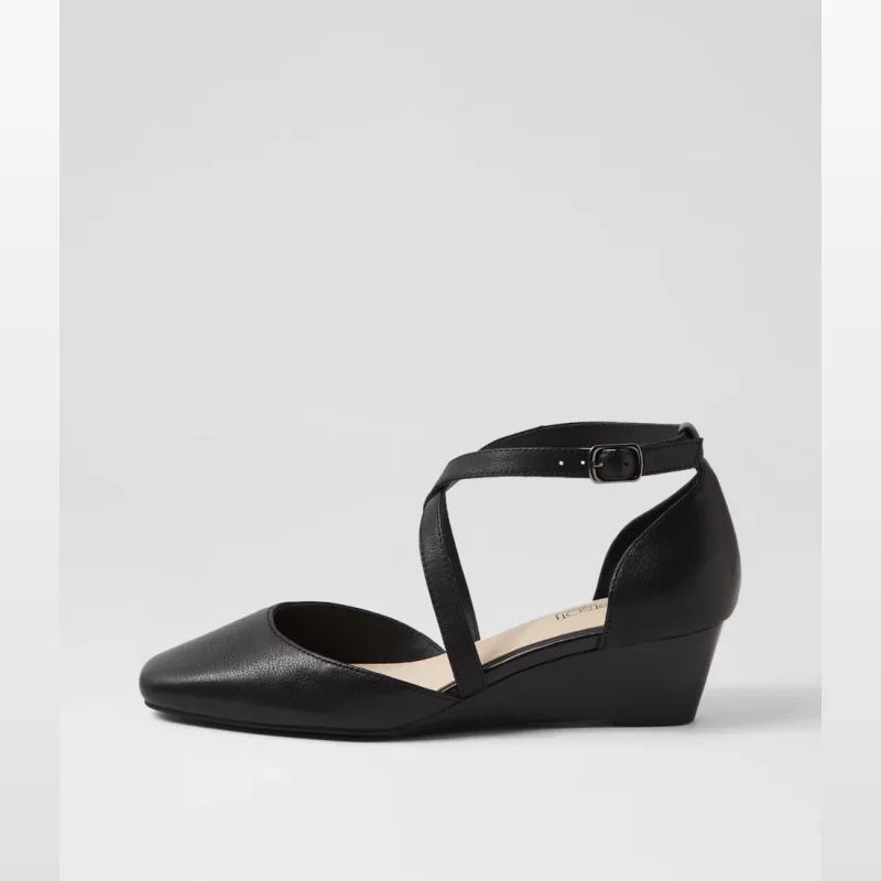 Black leather wedge heels with an ankle strap and criss-cross detailing.