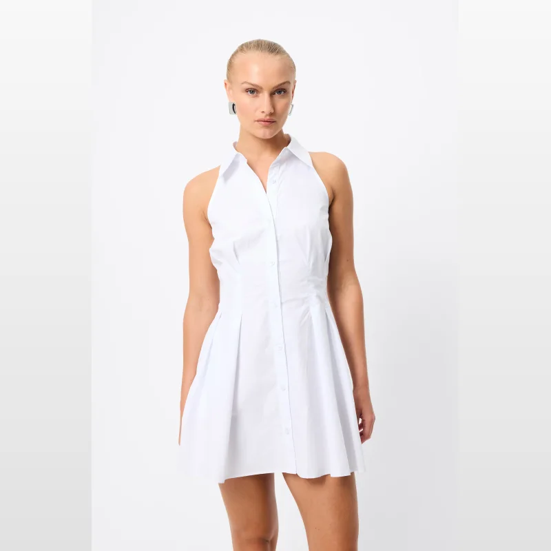 Woman wearing a white sleeveless collared mini shirt dress with a fitted bodice and semi-flared skirt.
