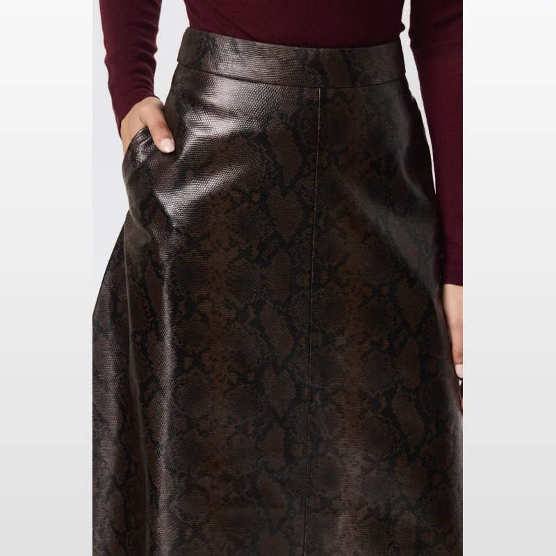 Model wearing a brown snake print faux leather midi skirt with an A-line silhouette and a burgundy off-the-shoulder top.