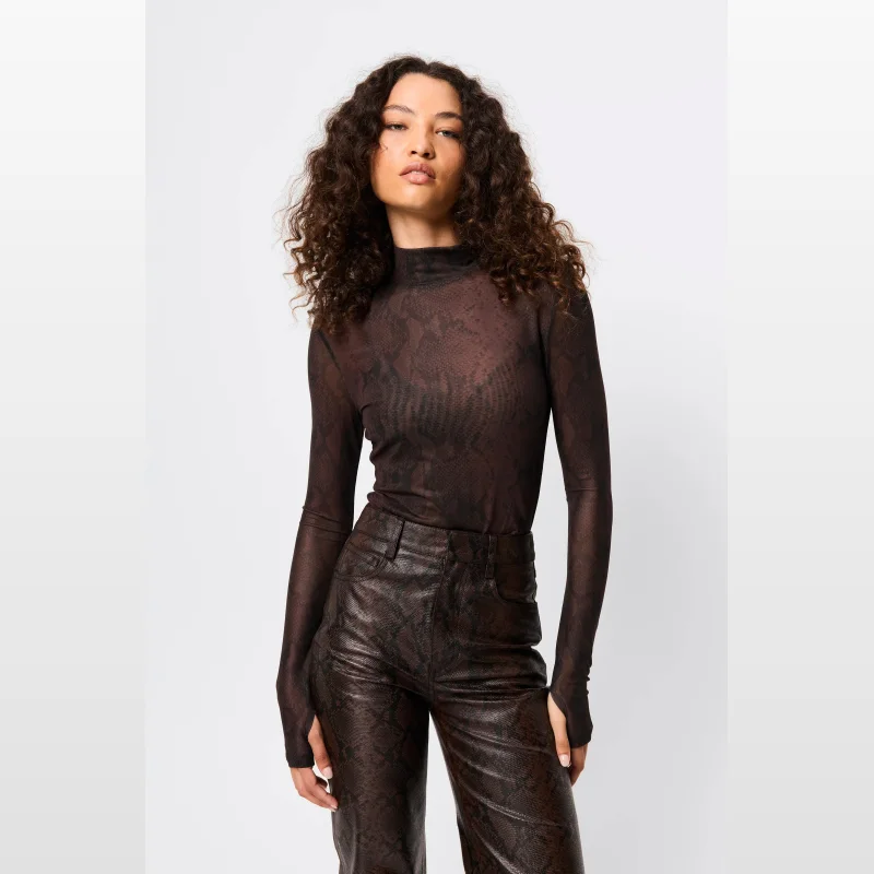 Model wearing a brown snake print mesh long sleeve turtleneck top with thumbholes.