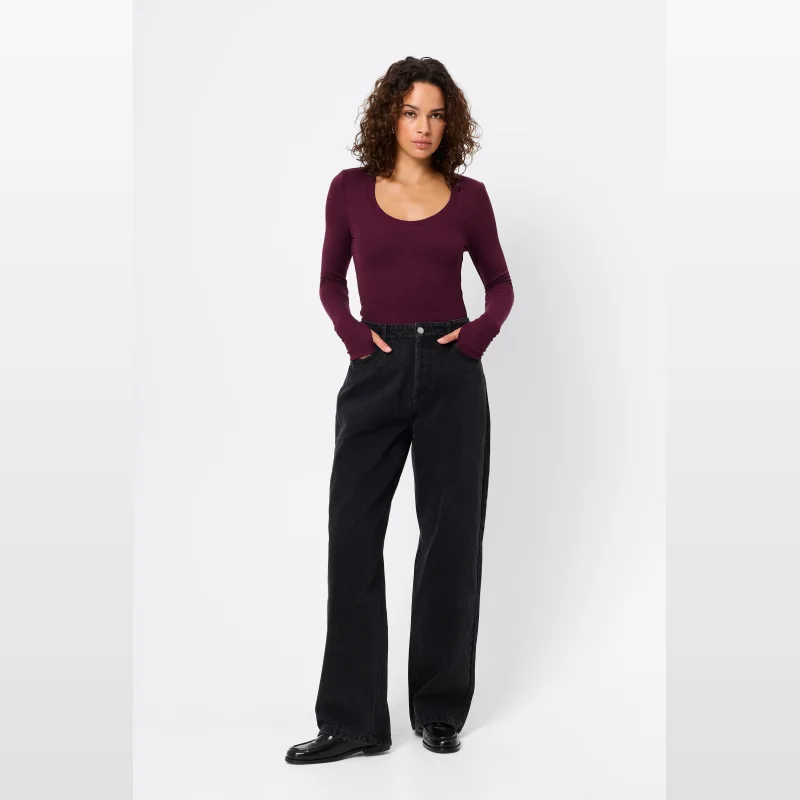 Woman wearing Mossman Frequency Jeans in black, a mid-waist, wide-leg denim style with a classic five-pocket design.